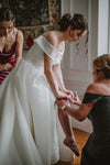 Mom and Sister Helping Bride Place Wedding Garter