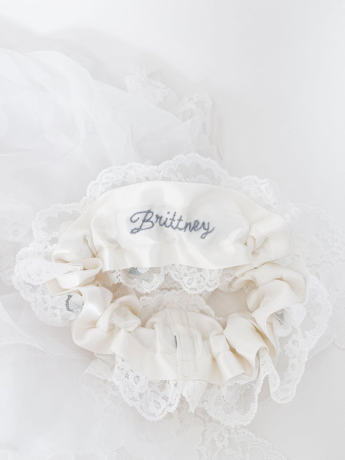 Custom wedding garter hand embroidered with bride's name by The Garter Girl