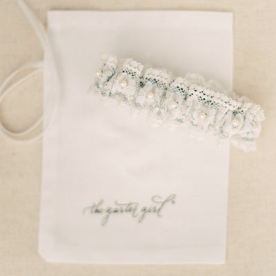 Shop our heirloom lace wedding garter, featuring pearls and vintage style.