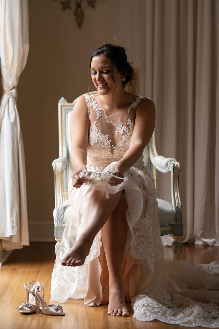 Bride wearing custom bridal garter made from grandmother's robe