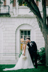 Bride and Groom Share a Kiss Under tree