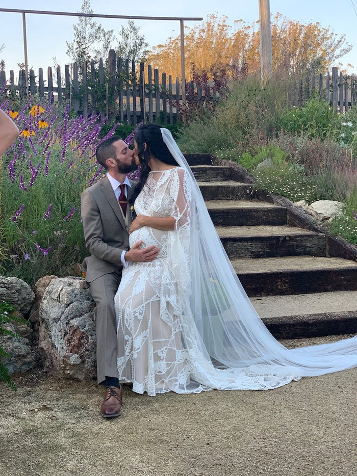 Bride and Groom Share a Kiss Long Cathedral Veil