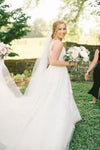 bride with long veil and white bridal bouquet