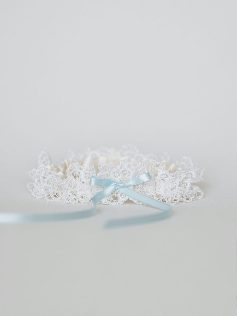 feminine wedding garter with lace and light blue satin and personalized hand embroidery by bridal accessories designer, The Garter Girl