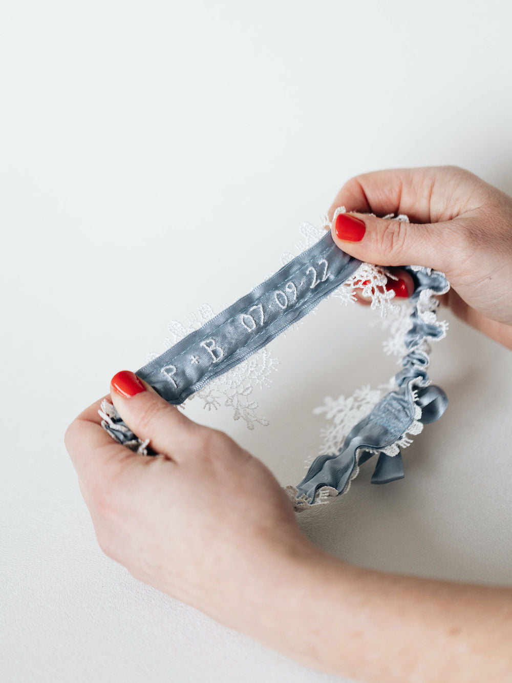 customized floral lace & dusty blue satin wedding garter personalized with hand embroidery by expert bridal accessory designer, The Garter Girl
