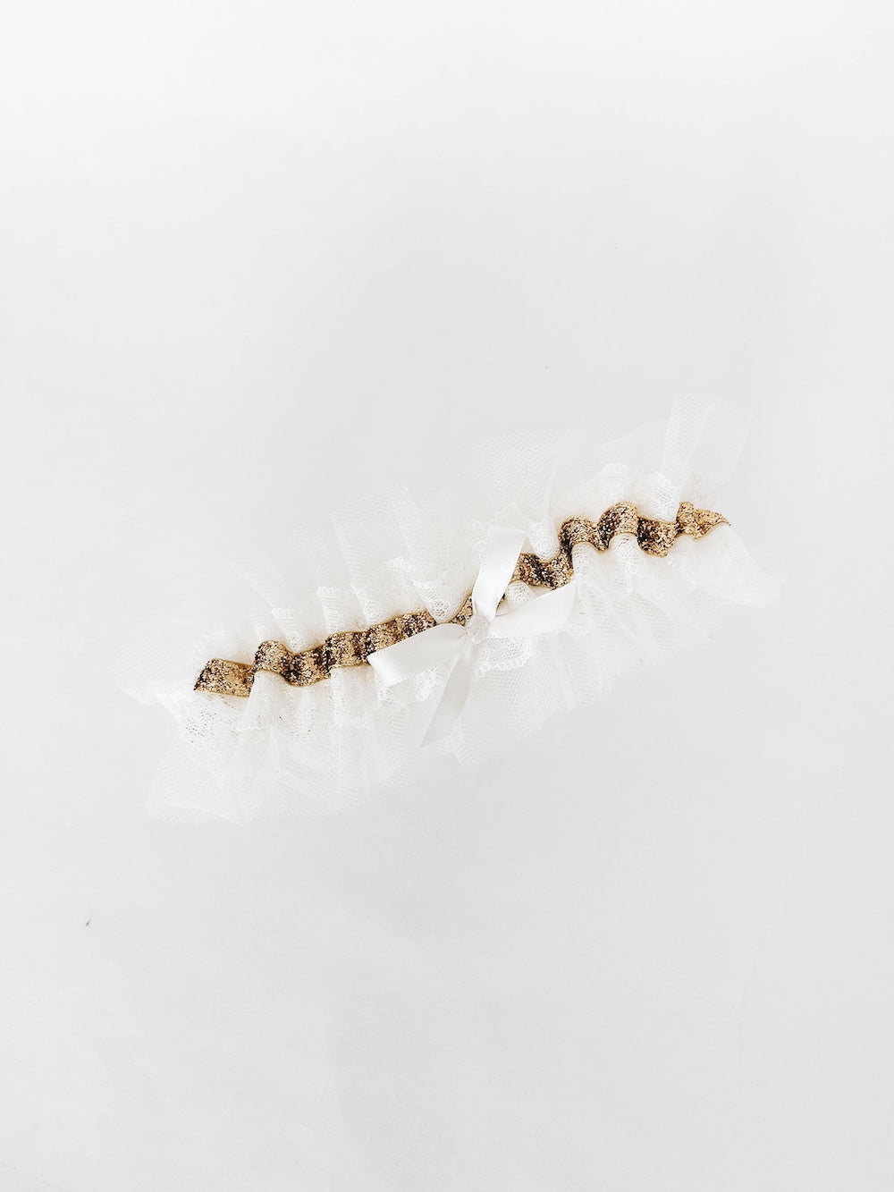 custom keepsake wedding garter heirloom with ivory lace and tulle with a gold band detail and a short-tail ivory satin bow handmade by The Garter Girl
