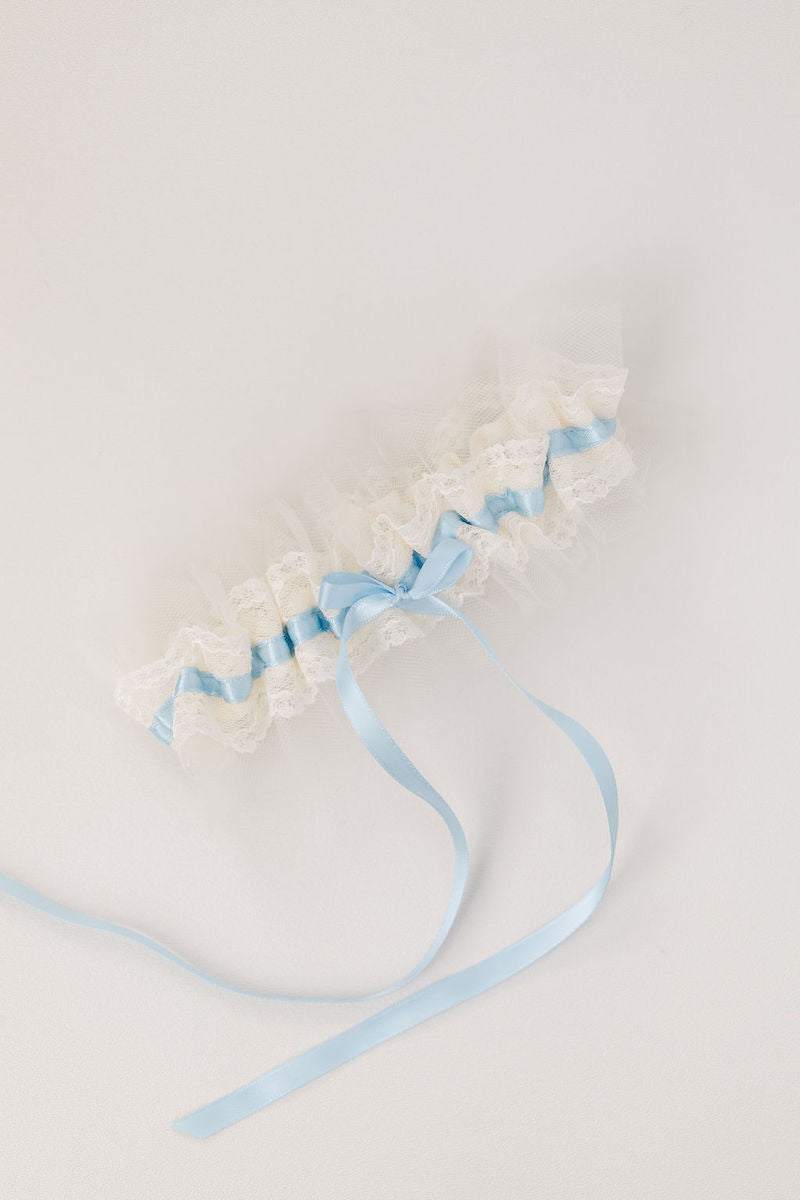 custom wedding garter with ivory tulle and lace with light blue satin and personalized with a pink heart embroidered