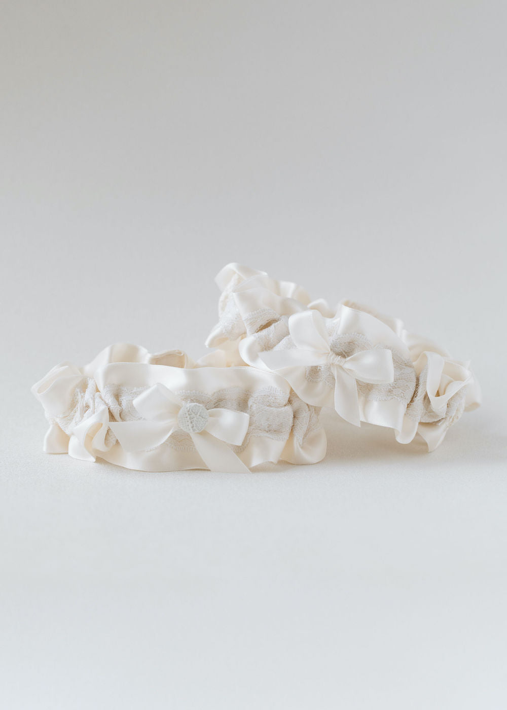 wedding garters handmade from bride's great grandmother's wedding dress lace material scraps w/ patch, embroidery, monogram & button detail, by expert bridal accessories designer, The Garter Girl