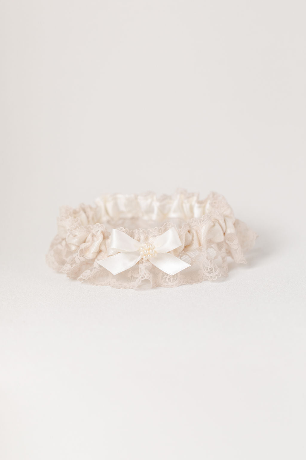 custom garter set with pearls and champagne lace