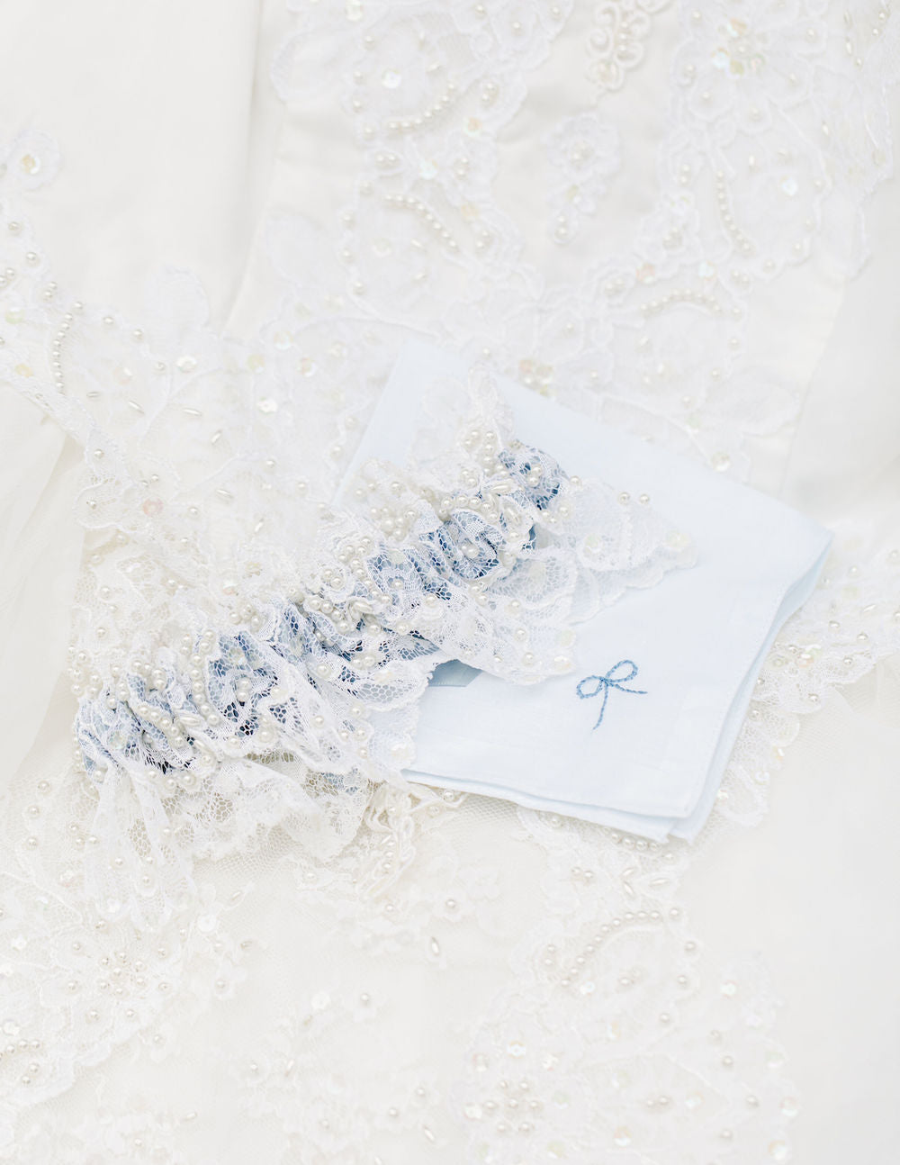 wedding garter heirloom handmade from the bride's mother's wedding dress hem with lace, pearls and dusty blue satin by The Garter Girl