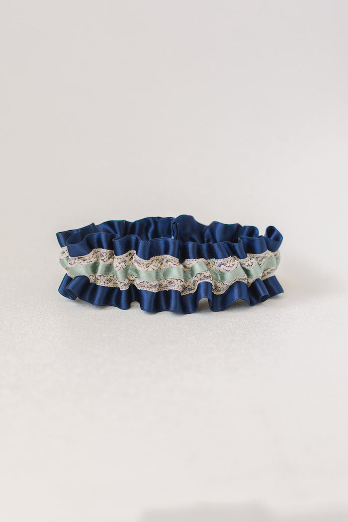custom garter made with navy blue, sage green and lace