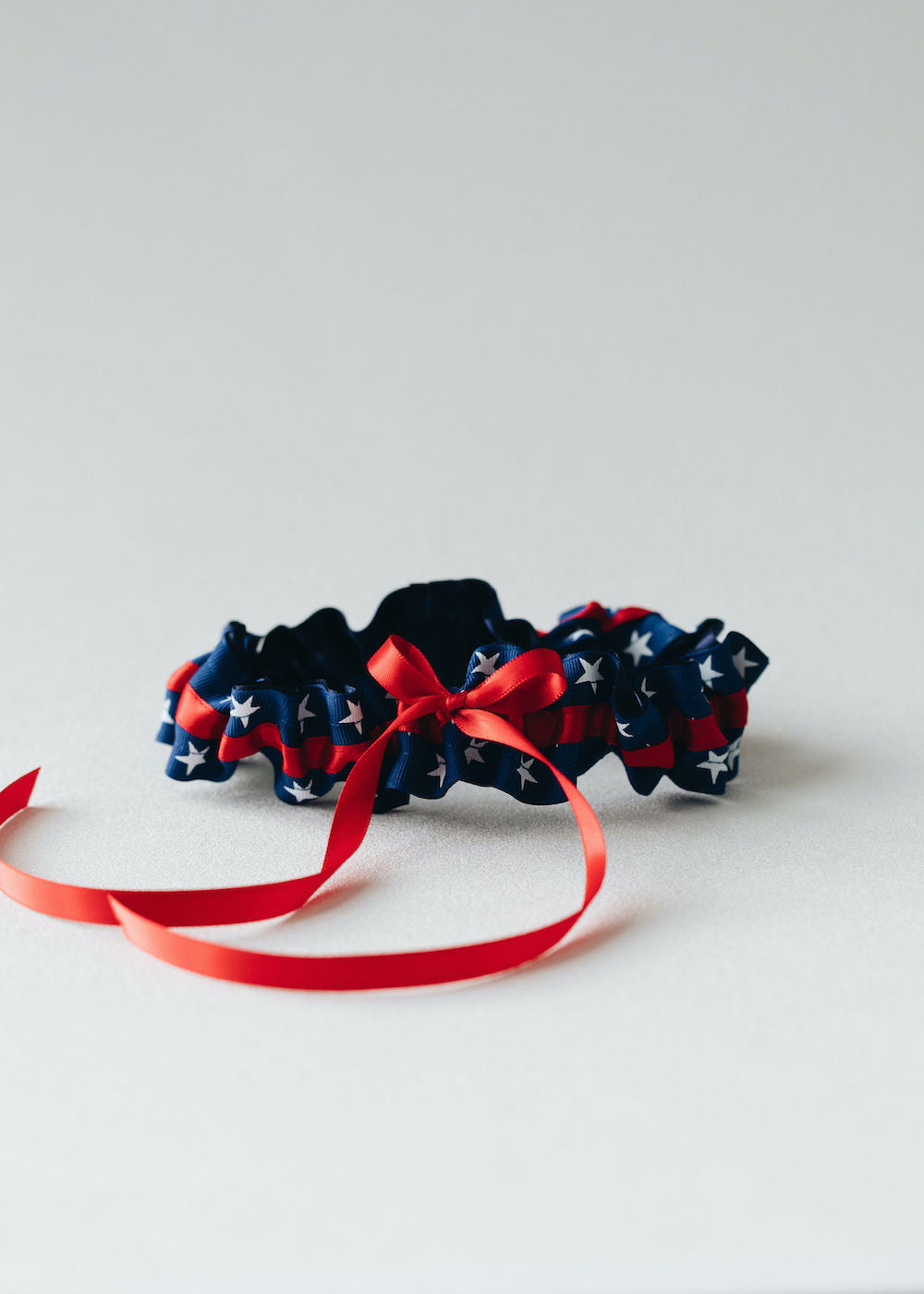 patriotic usa themed, red, white & blue wedding garter set personalized with couple's names and wedding date handmade bridal accessory by The Garter Girl