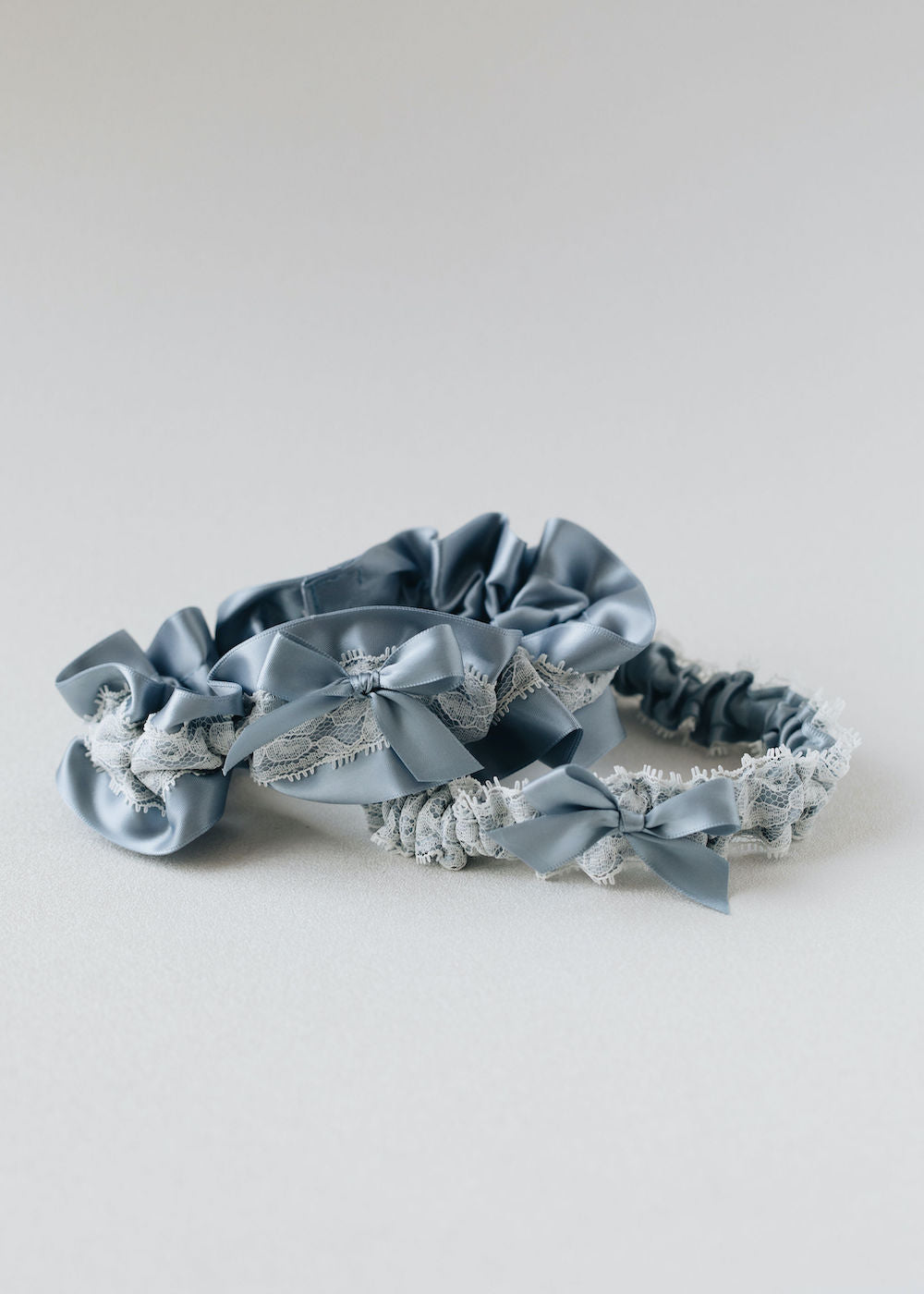 personalized handmade wedding garter set with dusty blue satin and ivory lace by expert bridal heirloom accessories designer, The Garter Girl