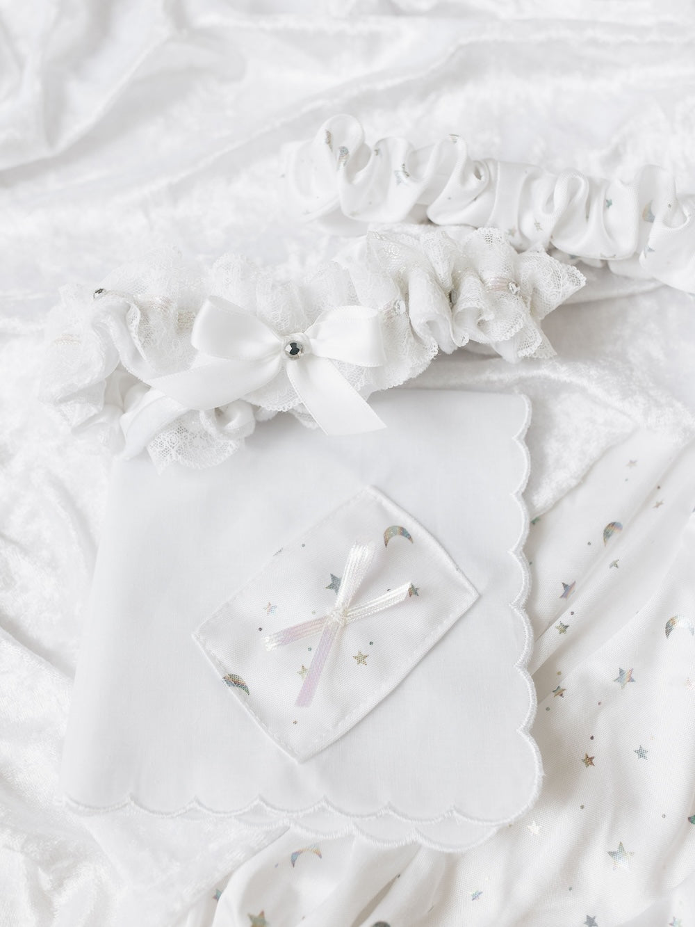heirloom set with velvet lace main wedding garter and sparkles alongside a velvet tossing garter and a scalloped edge white handkerchief with velvet and bow handmade by The Garter Girl