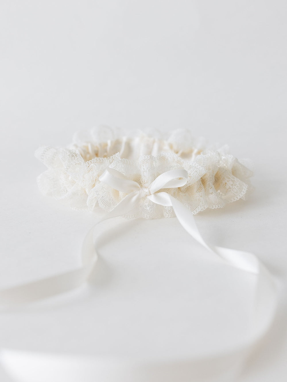 simple and elegant off white lace wedding garter heirloom with long tailed ivory satin bow handmade by The Garter Girl