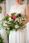 lush bridal bouquet and simple wedding dress