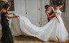 Bride and her family getting ready on wedding day with custom wedding garter made from bride's mom's wedding dress by The Garter Girl