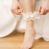 Shop our heirloom wedding garter with floral ivory lace and satin bow.
