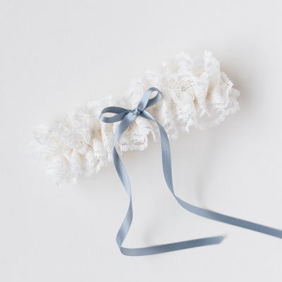 Shop The Garter Girl's handmade wedding garter heirloom with beautiful ivory lace and a something blue satin bow.