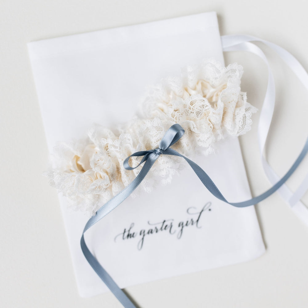 Shop The Garter Girl's handmade wedding garter heirloom with beautiful ivory lace and a something blue satin bow.