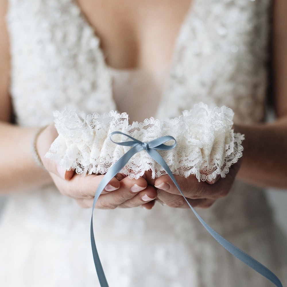 Shop The Garter Girl's handmade wedding garter heirloom with beautiful ivory lace and a something blue satin bow.