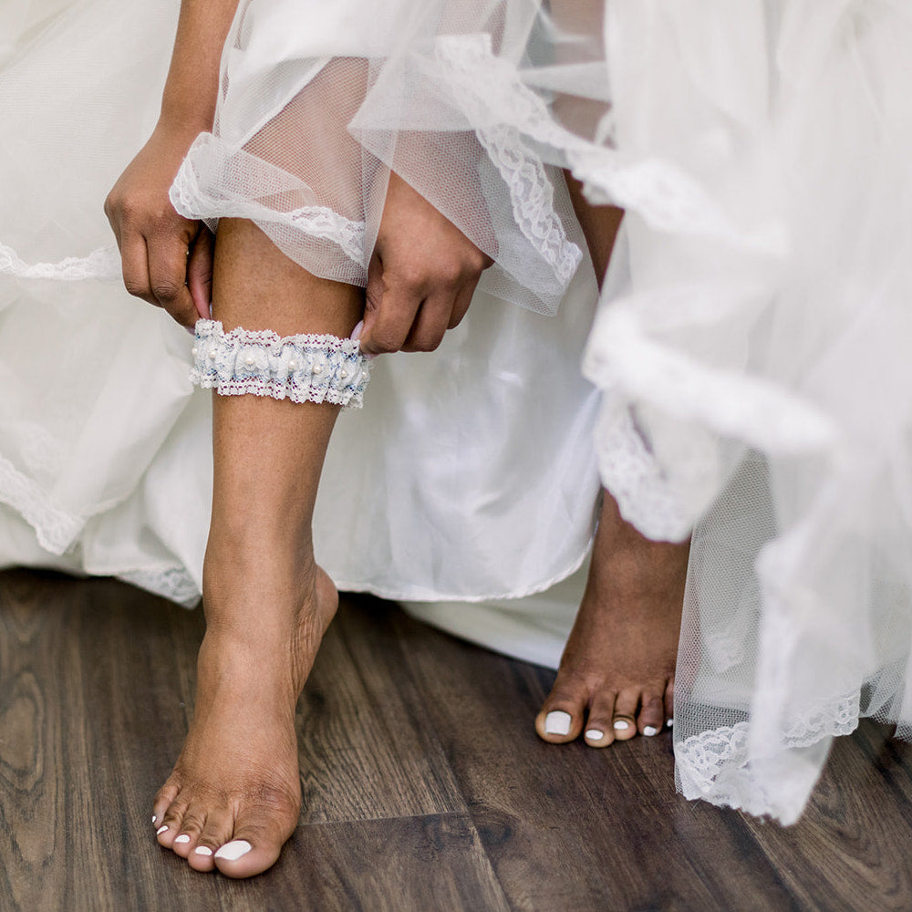 Shop our heirloom lace wedding garter, featuring pearls and vintage style.
