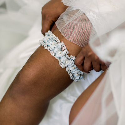Shop our heirloom lace wedding garter, featuring pearls and vintage style.