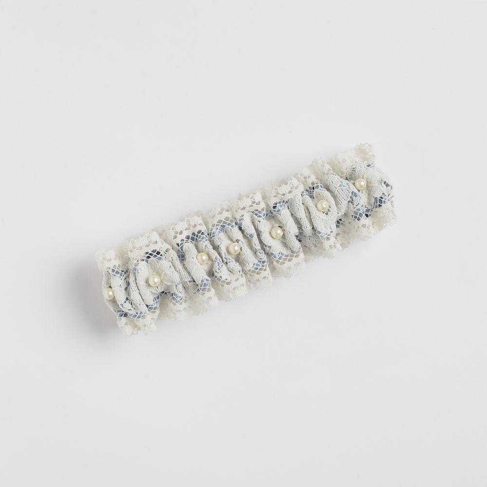 Shop our heirloom lace wedding garter, featuring pearls and vintage style.