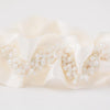 Shop our heirloom bridal garter with faux pearls, beads and ivory satin.