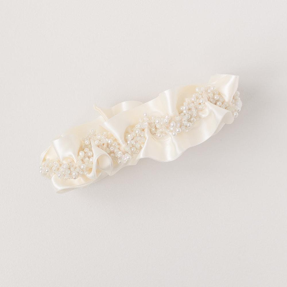 Shop our heirloom bridal garter with faux pearls, beads and ivory satin.