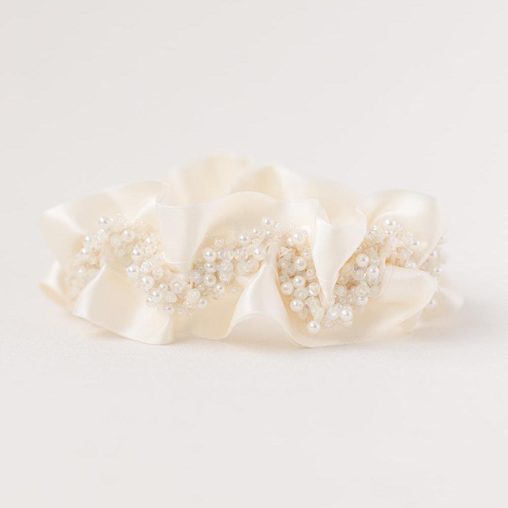 Shop our heirloom bridal garter with faux pearls, beads and ivory satin.